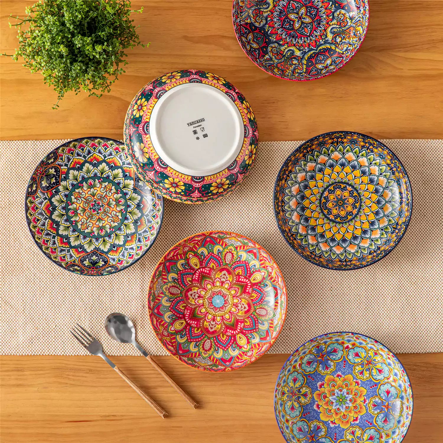 Vibrant Lumi porcelain pasta bowls filled with fruit salad pumpkin soup and pasta on a wooden dining table