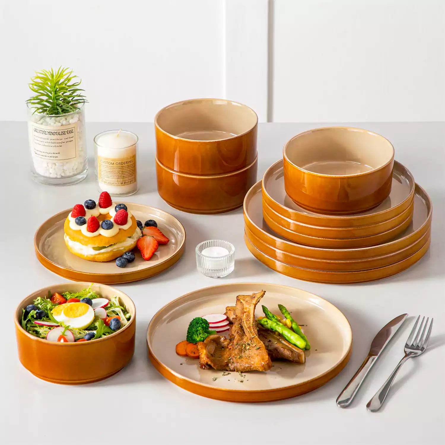 A rustic breakfast spread featuring a plate of meat with vegetables - waffles topped with fruit - and assorted pastries on a white table - complemented by caramel stoneware dinnerware