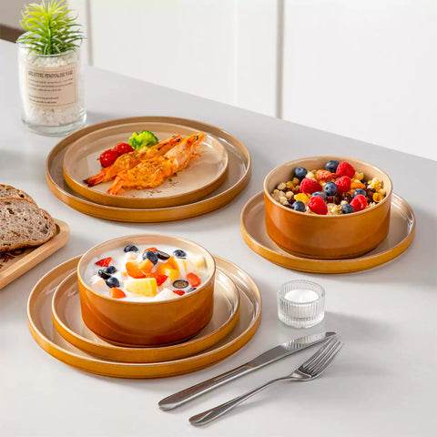 A rustic breakfast spread featuring a plate of meat with vegetables - waffles topped with fruit - and assorted pastries on a white table - complemented by caramel stoneware dinnerware