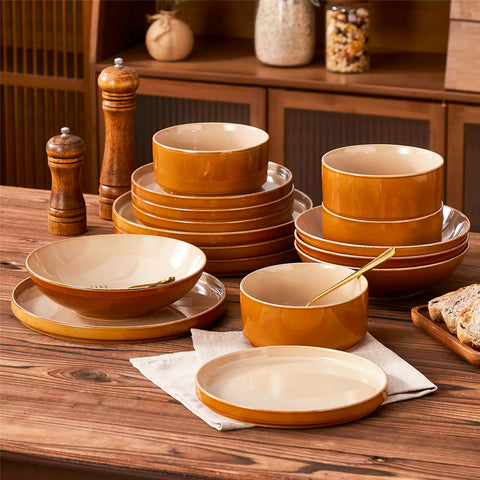 Assorted family dinnerware on wooden table brown stoneware soup bowl pasta with shrimp fruit tart and bread perfect for everyday meals