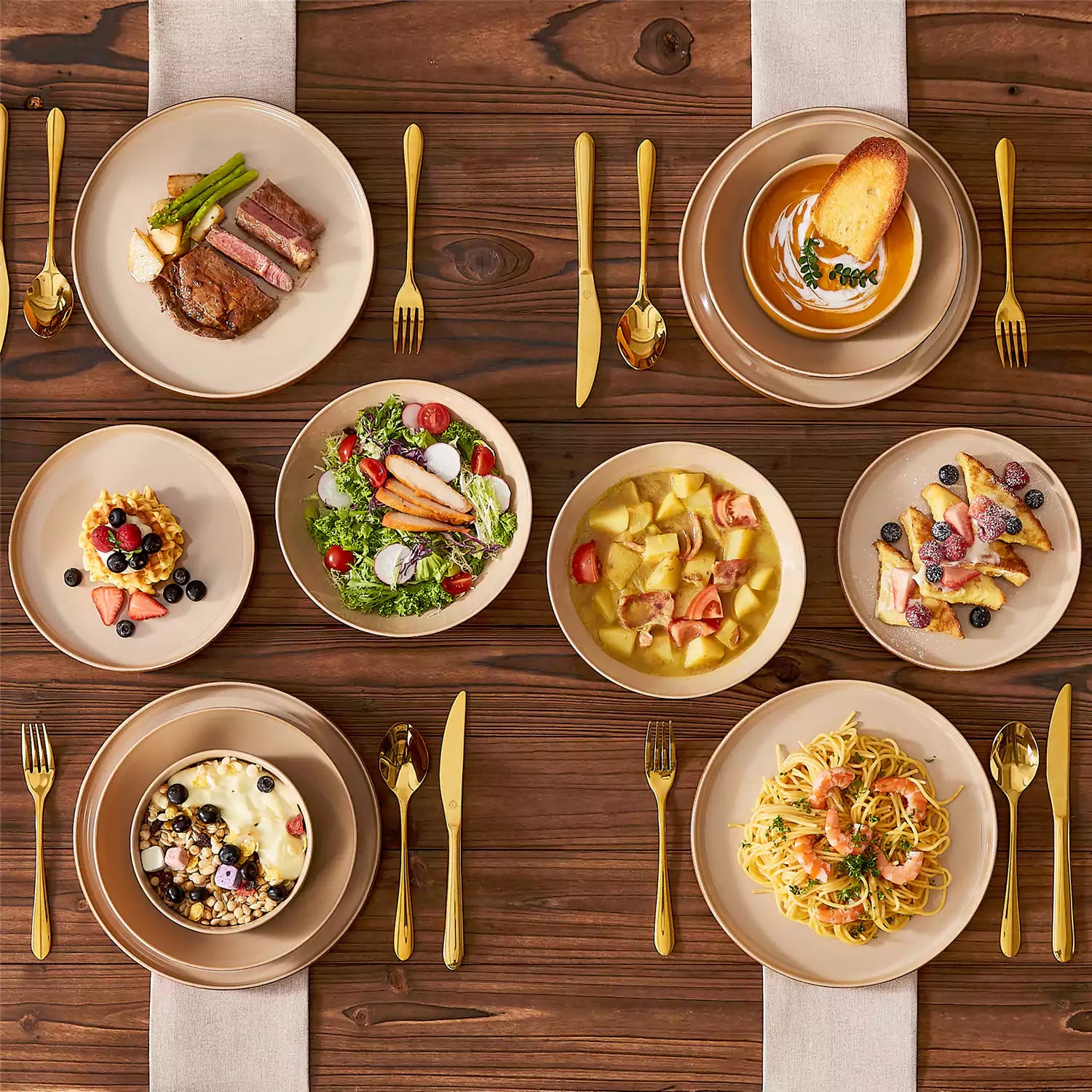 Assorted family dinnerware on wooden table brown stoneware soup bowl pasta with shrimp fruit tart and bread perfect for everyday meals