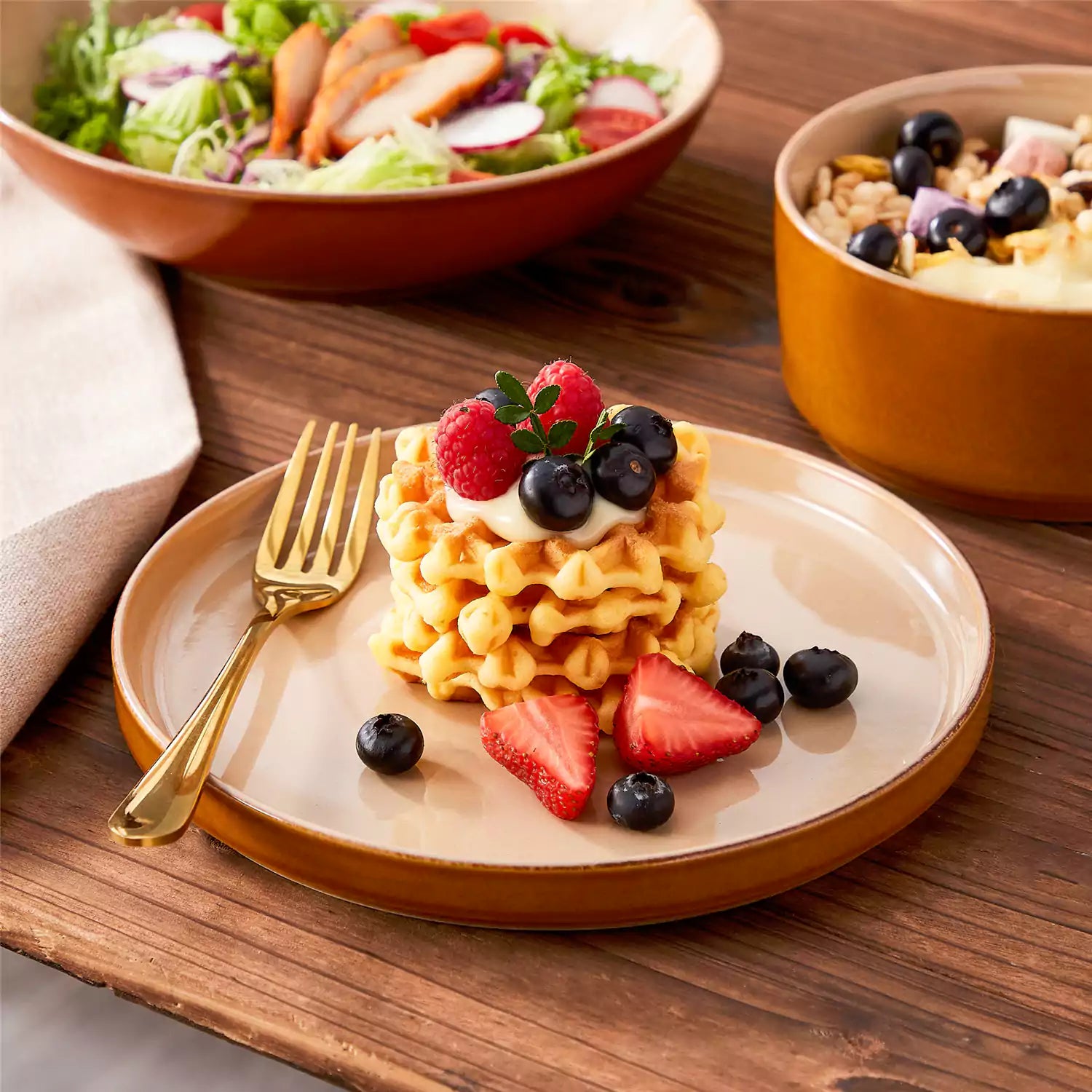 Assorted family dinnerware on wooden table brown stoneware soup bowl pasta with shrimp fruit tart and bread perfect for everyday meals