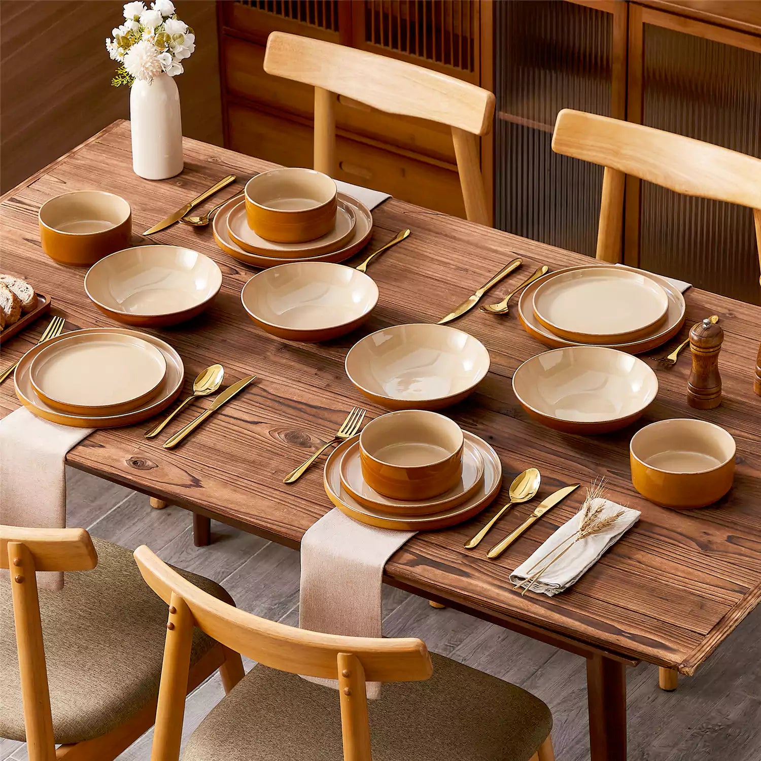 Assorted family dinnerware on wooden table brown stoneware soup bowl pasta with shrimp fruit tart and bread perfect for everyday meals