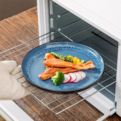 A glossy blue 16-piece stoneware dinnerware set from the Playa collection - featuring farmhouse charm with plates and bowls for 4 people-vancasso