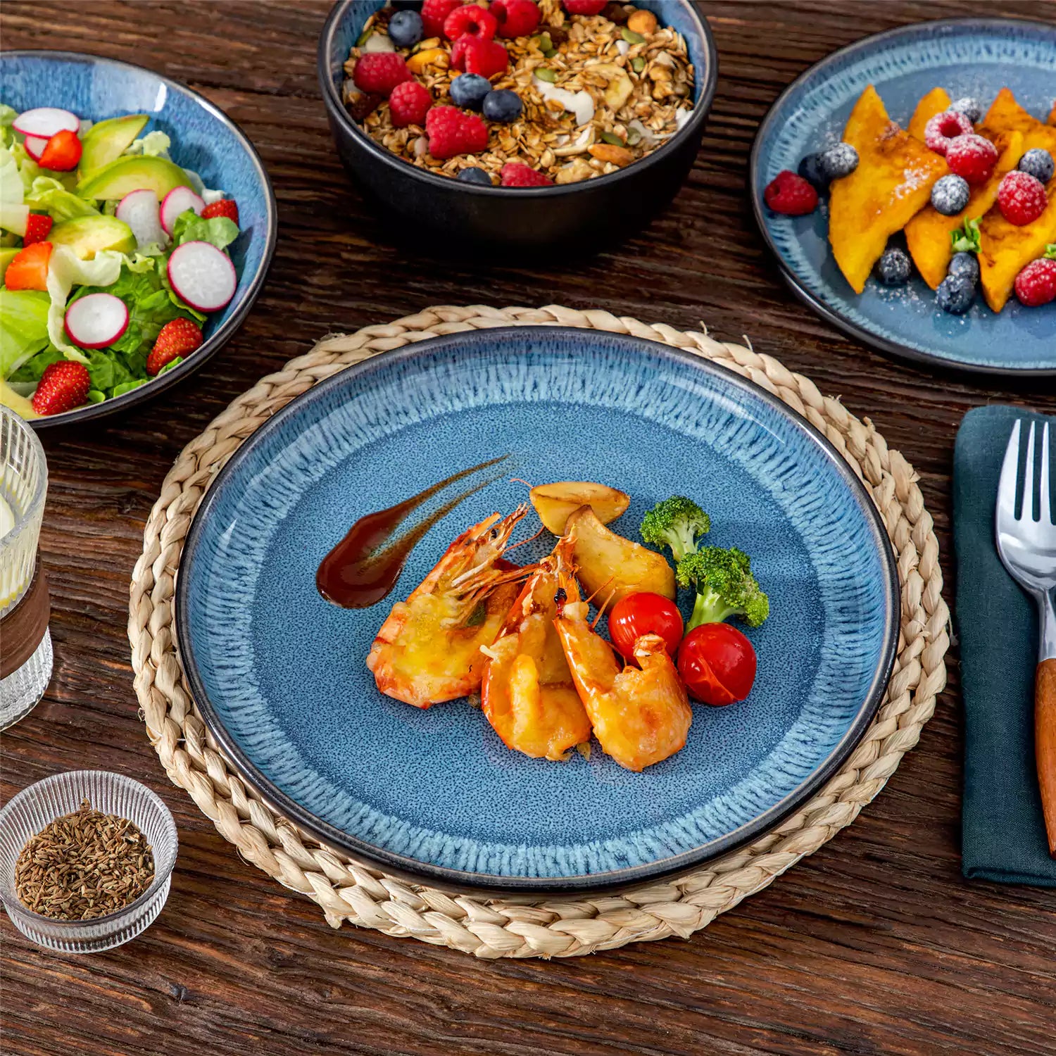 A glossy blue 16-piece stoneware dinnerware set from the Playa collection - featuring farmhouse charm with plates and bowls for 4 people-vancasso