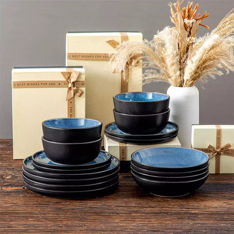 A glossy blue 16-piece stoneware dinnerware set from the Playa collection - featuring farmhouse charm with plates and bowls for 4 people-vancasso