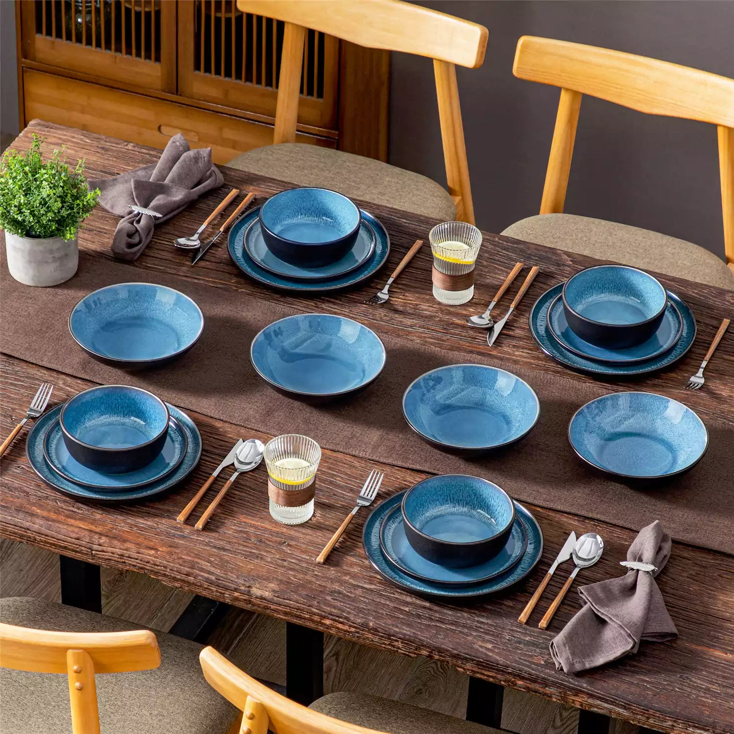 A glossy blue 16-piece stoneware dinnerware set from the Playa collection - featuring farmhouse charm with plates and bowls for 4 people-vancasso