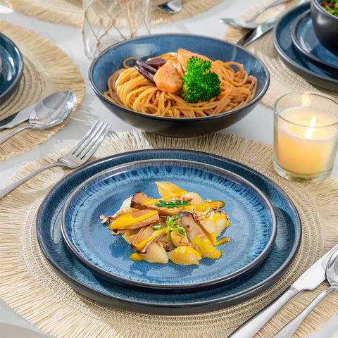 A glossy blue 24-piece stoneware dinnerware set from the Playa collection - featuring farmhouse charm with plates and bowls for 6 people-vancasso