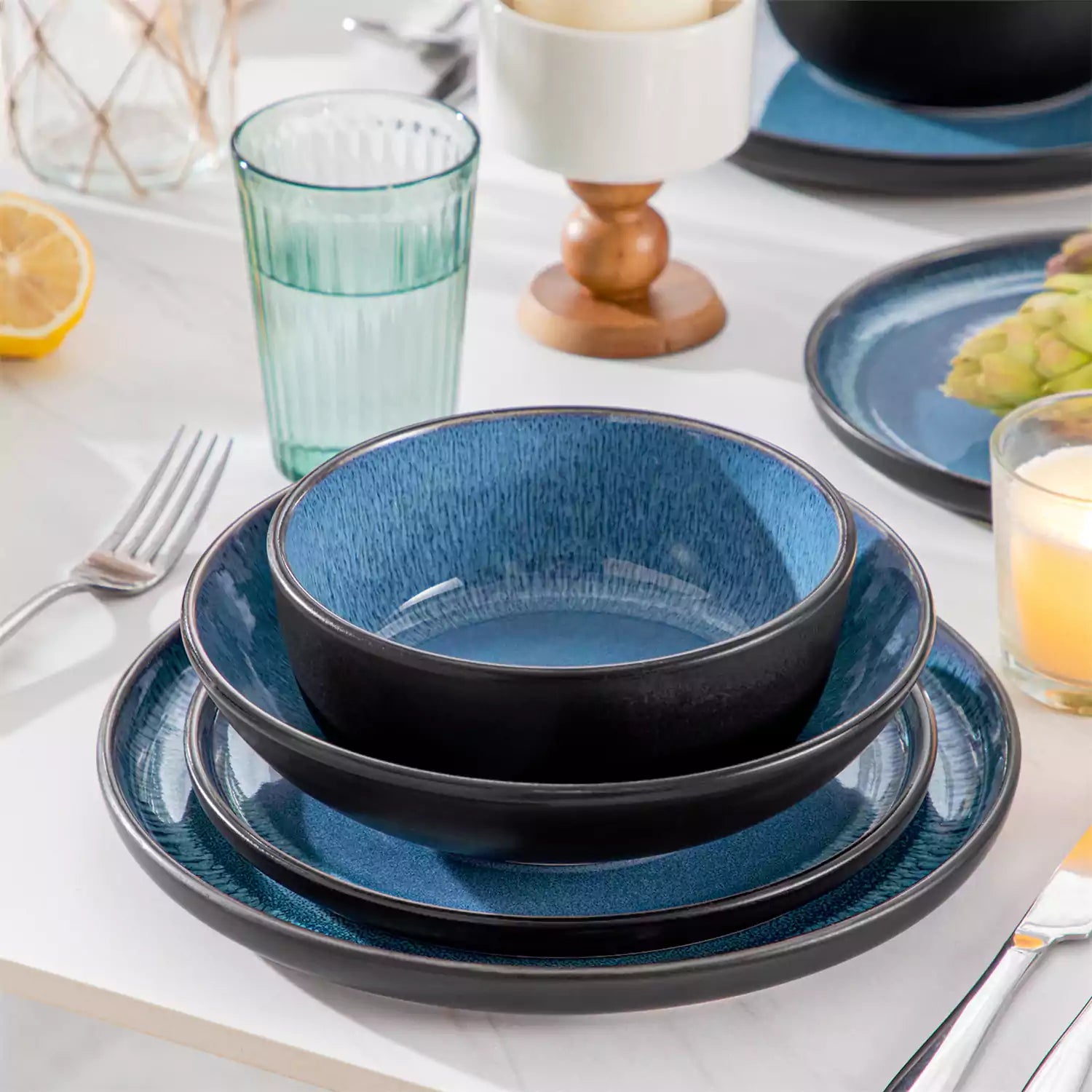 A glossy blue 24-piece stoneware dinnerware set from the Playa collection - featuring farmhouse charm with plates and bowls for 6 people-vancasso