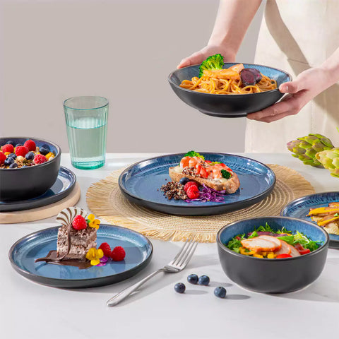 A glossy blue 24-piece stoneware dinnerware set from the Playa collection - featuring farmhouse charm with plates and bowls for 6 people-vancasso