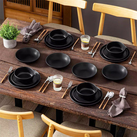 A matte black 16-piece stoneware dinnerware set from the Playa collection - offering a modern touch with plates and bowls for 4 people-vancasso.