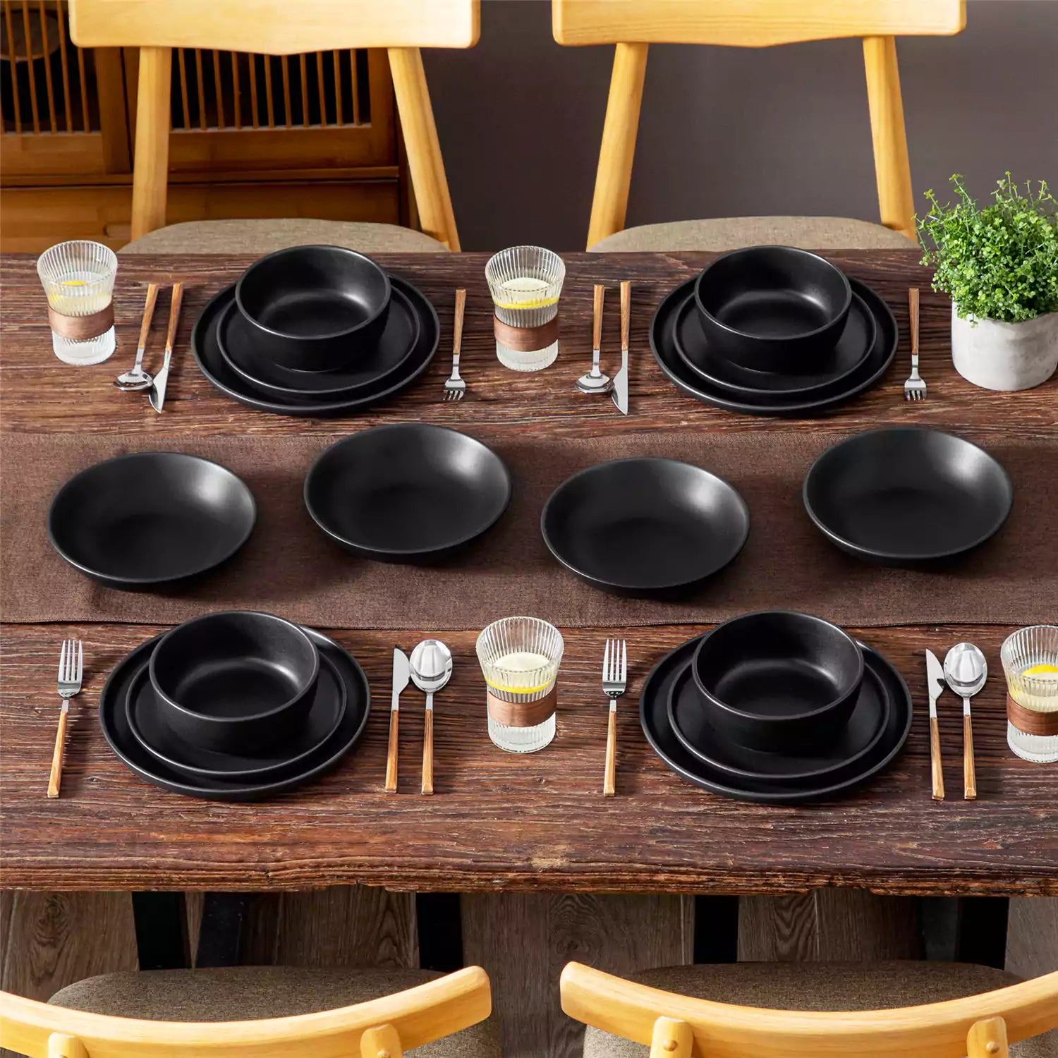 A matte black 16-piece stoneware dinnerware set from the Playa collection - offering a modern touch with plates and bowls for 4 people-vancasso.