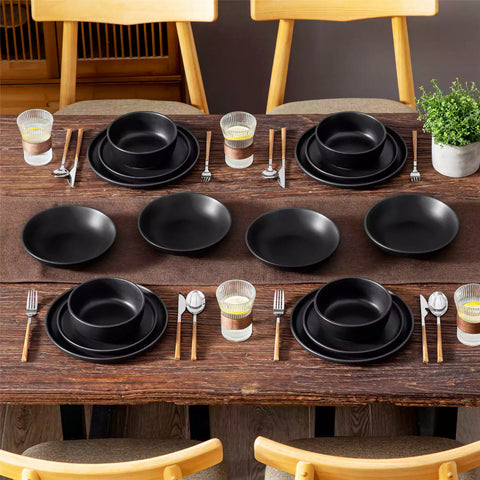 A matte black 16-piece stoneware dinnerware set from the Playa collection - offering a modern touch with plates and bowls for 4 people-vancasso.