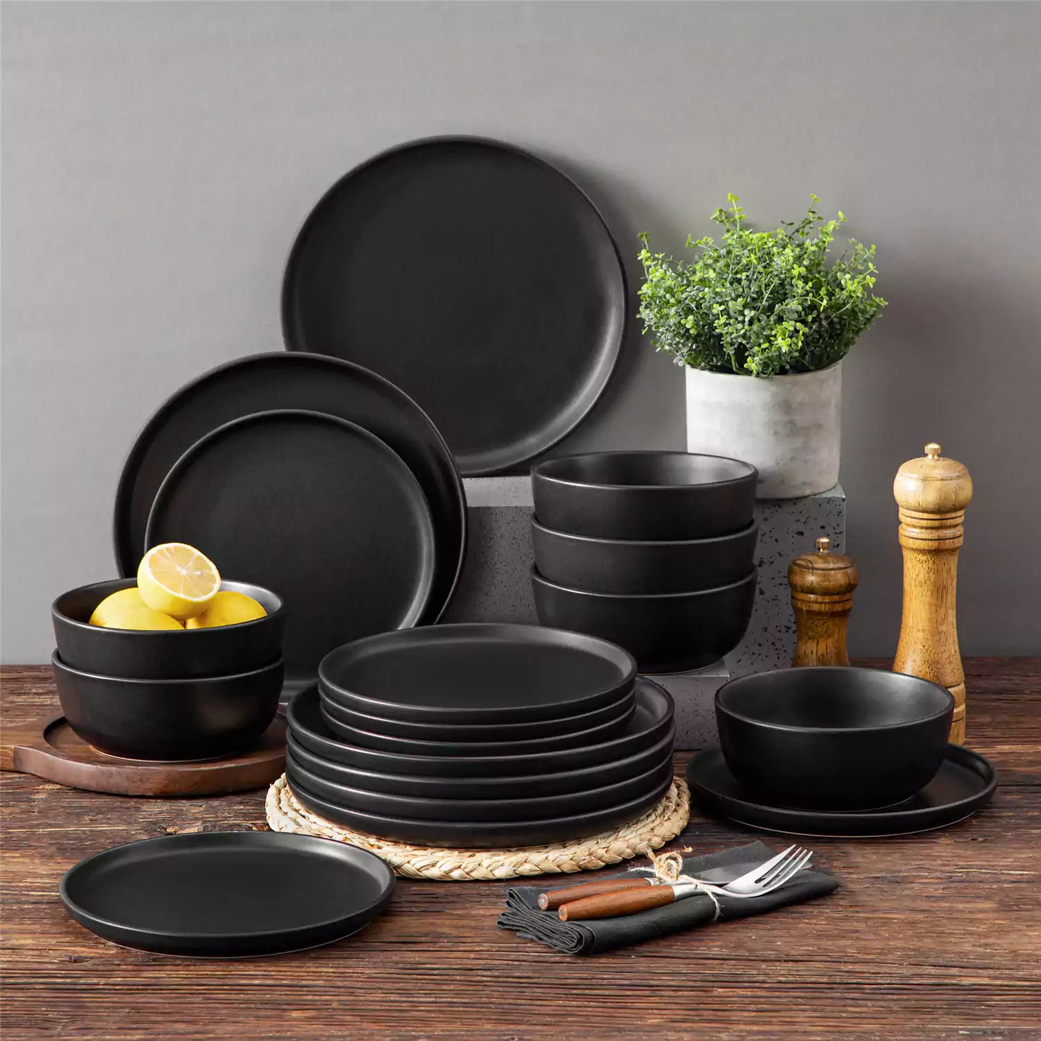 Playa 18-Piece Stoneware Dinnerware Set for 6, featuring plates and bowls in a modern Ibiza-inspired style with a matte black finish-vancasso