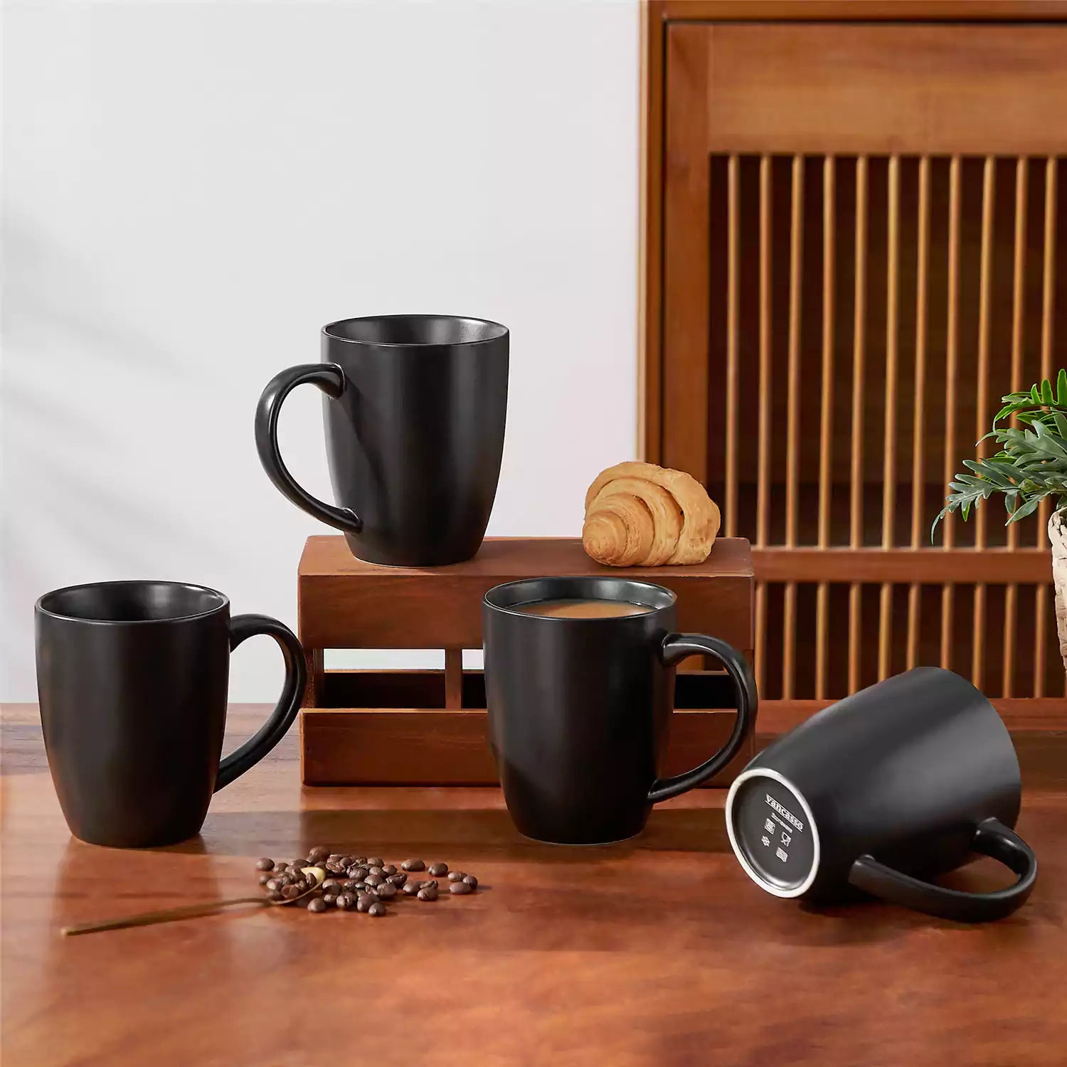 Playa 16oz stoneware mug in black on a rustic wooden kitchen table for a modern breakfast with coffee and fresh fruit