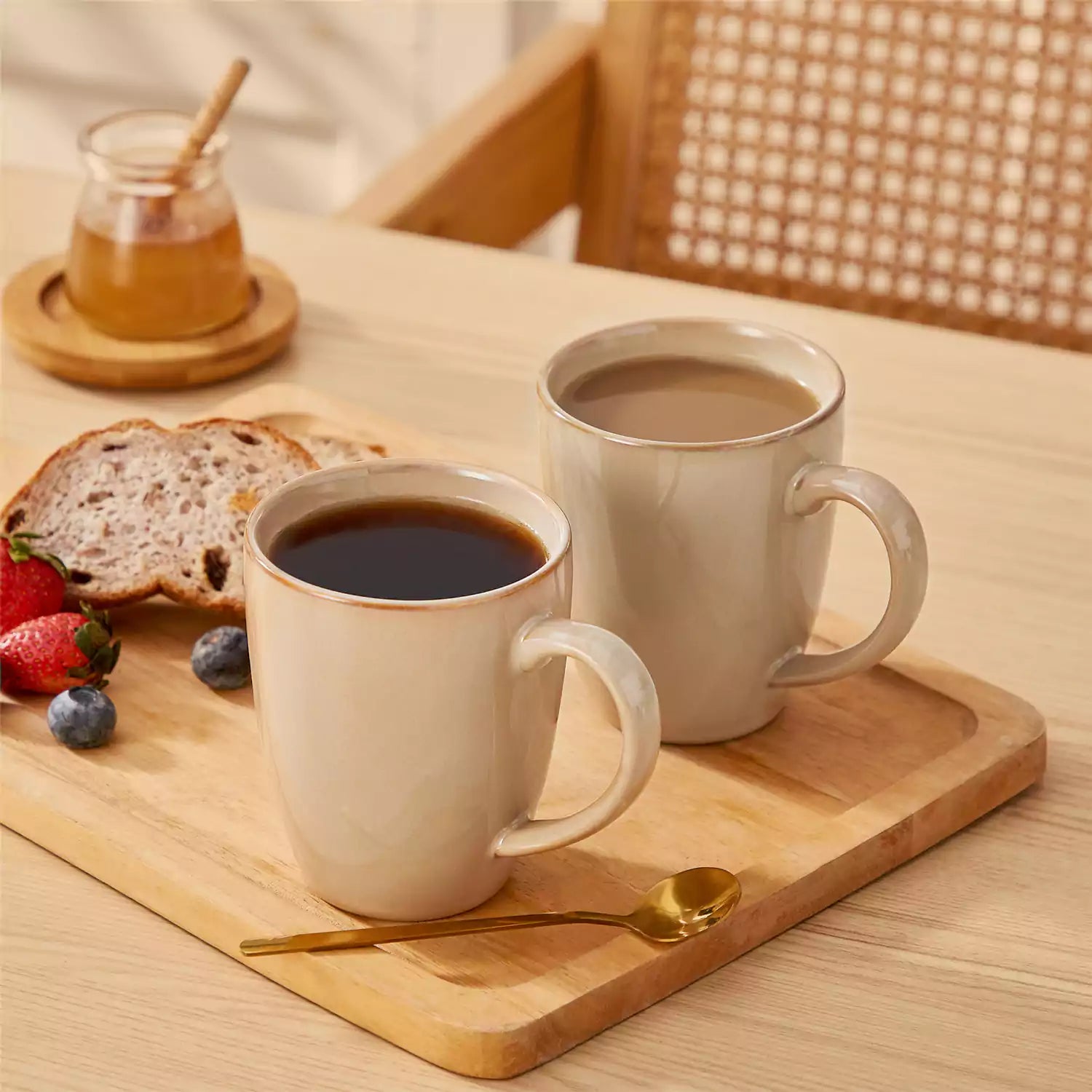 Playa 16oz stoneware mugs in brown reactive glaze on a rustic wooden surface for a cozy morning pour with coffee carafe and scattered beans