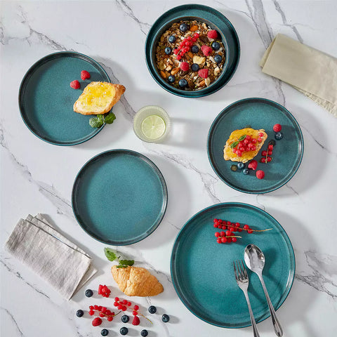 A glossy teal 24-piece stoneware dinnerware set from the Playa collection - featuring farmhouse charm with plates and bowls for 6 people-vancasso