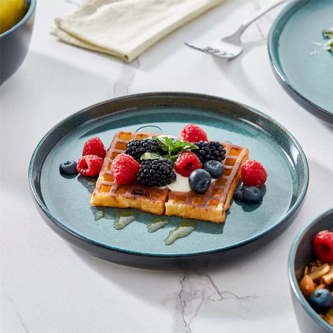 A glossy teal 24-piece stoneware dinnerware set from the Playa collection - featuring farmhouse charm with plates and bowls for 6 people-vancasso