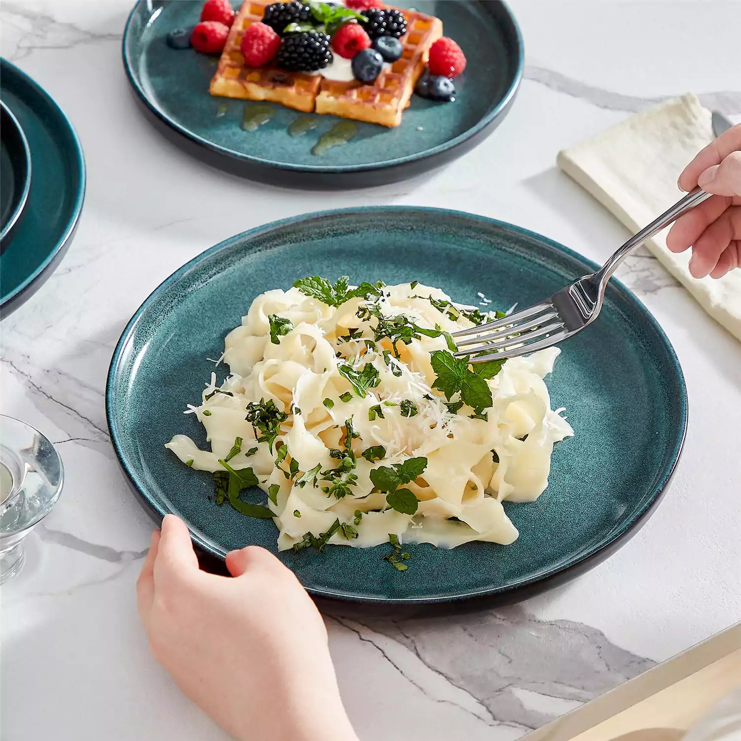 A glossy teal 24-piece stoneware dinnerware set from the Playa collection - featuring farmhouse charm with plates and bowls for 6 people-vancasso
