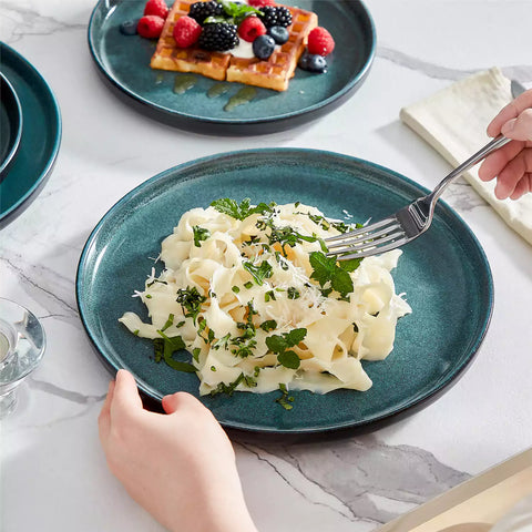 A glossy teal 24-piece stoneware dinnerware set from the Playa collection - featuring farmhouse charm with plates and bowls for 6 people-vancasso