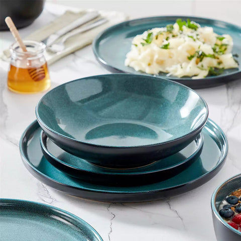 A glossy teal 24-piece stoneware dinnerware set from the Playa collection - featuring farmhouse charm with plates and bowls for 6 people-vancasso