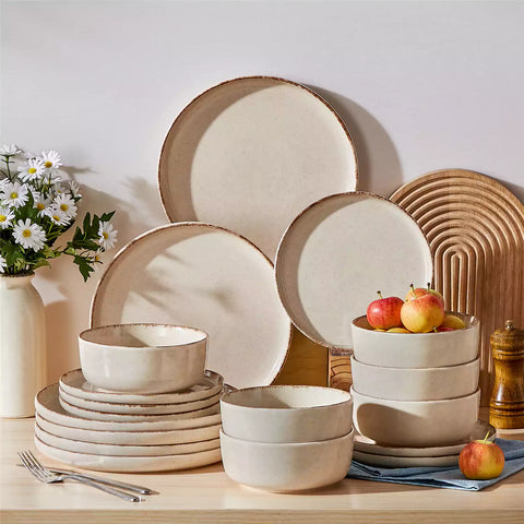 Plays 18-piece stoneware dinnerware set with steak and vegetables on marble table - featuring sandy speckled plates and bowls with brown rims-vancasso