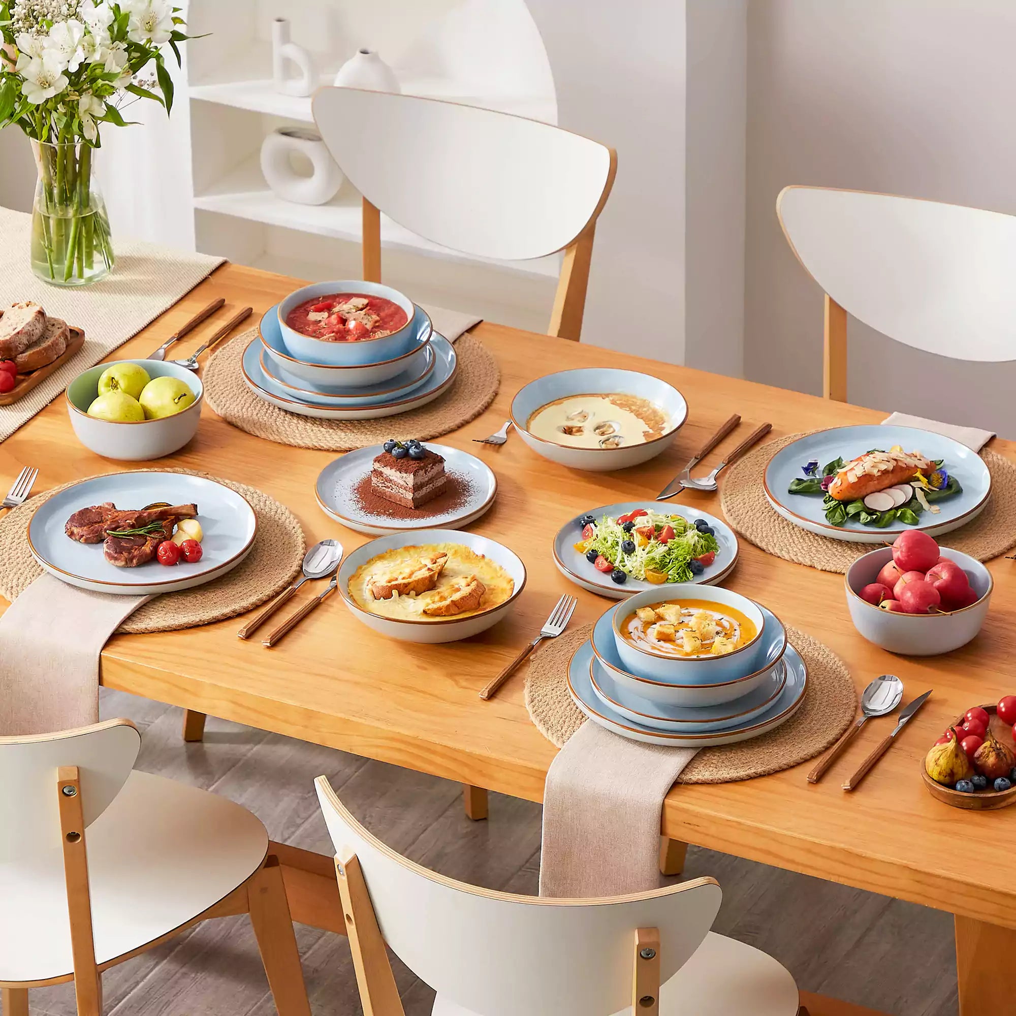Rustic blue speckled stoneware dinnerware set with lipped-edge plates and bowls arranged on a sunlit modern dining table-vancasso