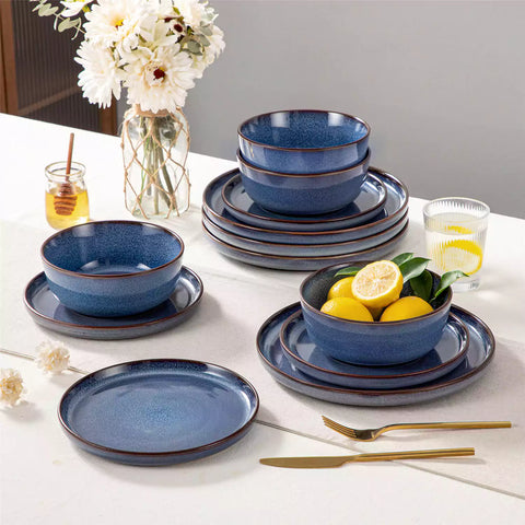 Sata blue stoneware 12 piece dinnerware set with dinner plates salad plates and cereal bowls styled with gold cutlery on textured surface farmhouse reactive glaze lipped edge service for 4