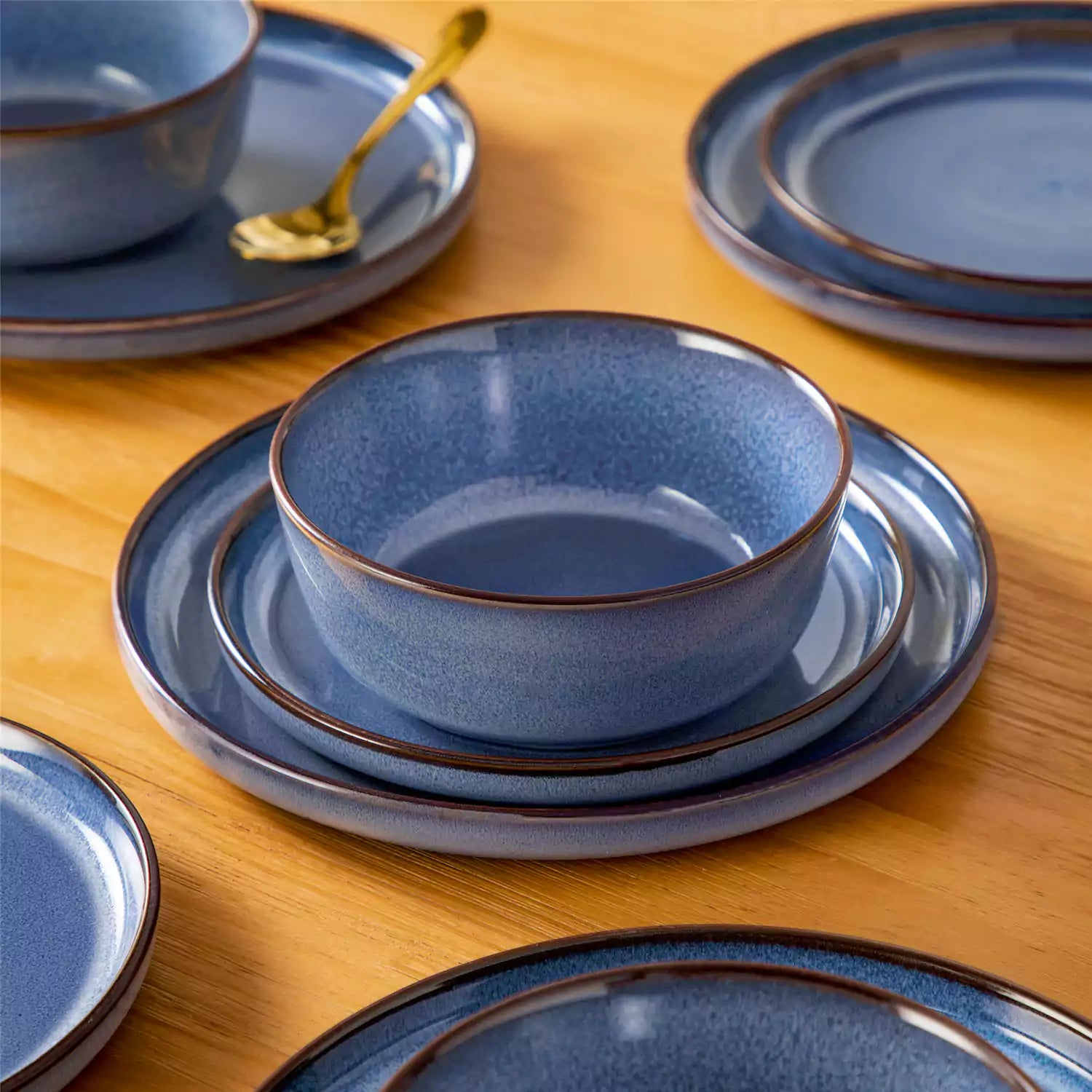 Sata blue stoneware 18 piece dinnerware set with dinner plates salad plates and cereal bowls styled on a wooden table with diverse meal setup farmhouse reactive glaze lipped edge service for 6