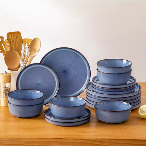 Sata blue stoneware 18 piece dinnerware set with dinner plates salad plates and cereal bowls styled on a wooden table with diverse meal setup farmhouse reactive glaze lipped edge service for 6