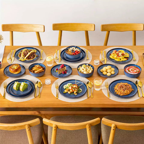 Sata blue stoneware 18 piece dinnerware set with dinner plates salad plates and cereal bowls styled on a wooden table with diverse meal setup farmhouse reactive glaze lipped edge service for 6