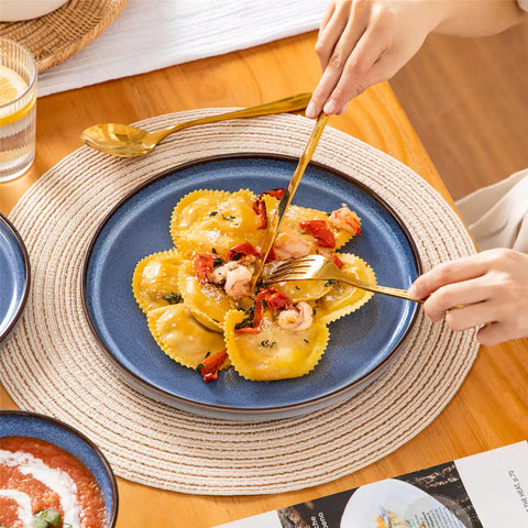 Sata blue stoneware 18 piece dinnerware set with dinner plates salad plates and cereal bowls styled on a wooden table with diverse meal setup farmhouse reactive glaze lipped edge service for 6