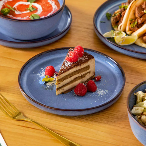 Sata blue stoneware 18 piece dinnerware set with dinner plates salad plates and cereal bowls styled on a wooden table with diverse meal setup farmhouse reactive glaze lipped edge service for 6