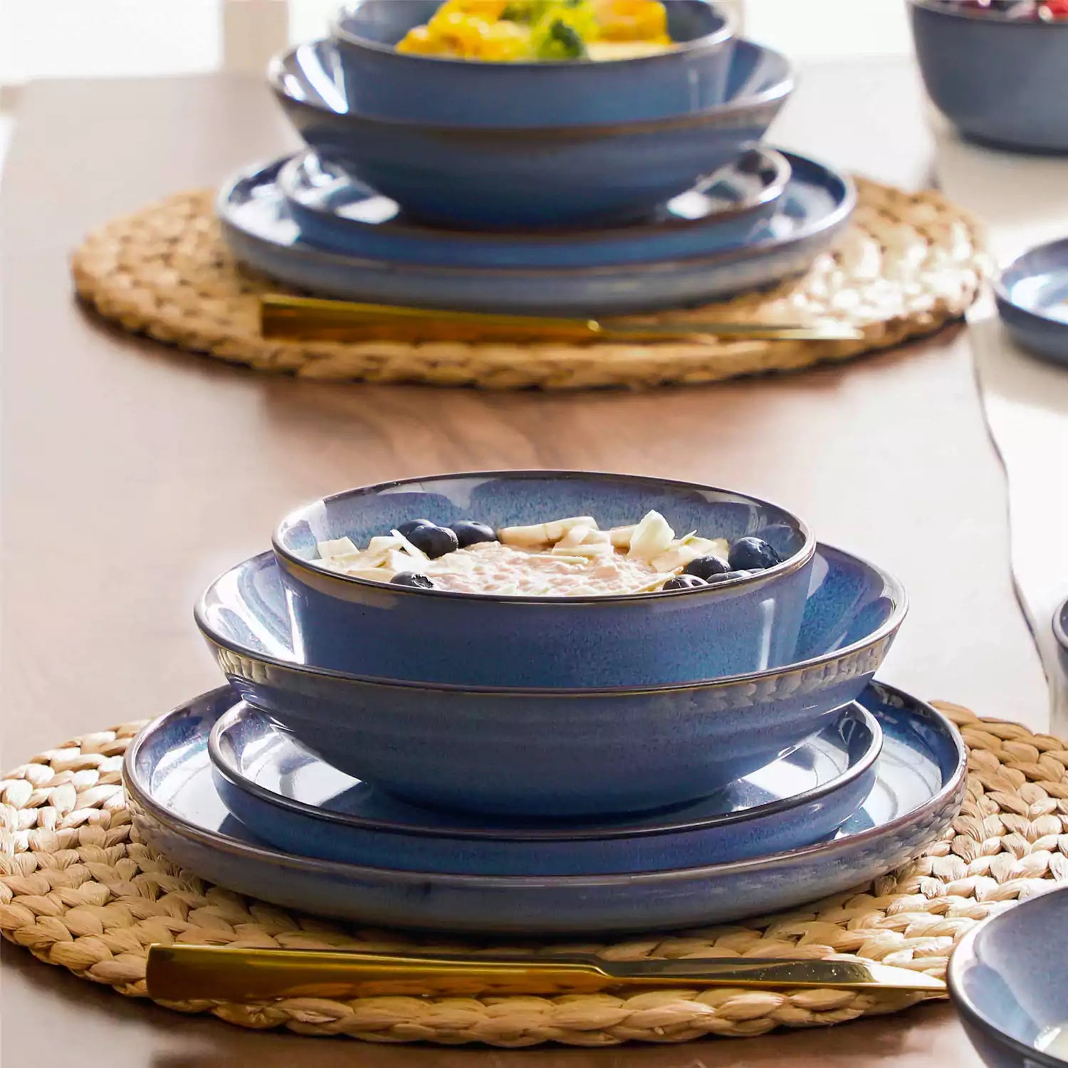 Sata blue stoneware dinnerware set styled dining table with dinner plates salad plates pasta bowls cereal bowls silverware and floral centerpiece farmhouse reactive glaze service for 6