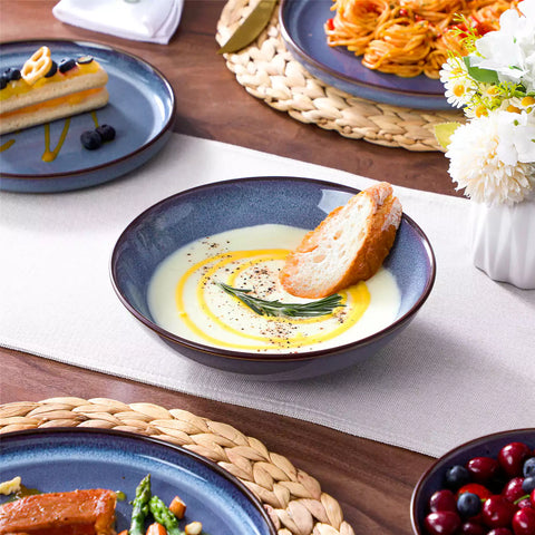 Sata blue stoneware dinnerware set styled dining table with dinner plates salad plates pasta bowls cereal bowls silverware and floral centerpiece farmhouse reactive glaze service for 6