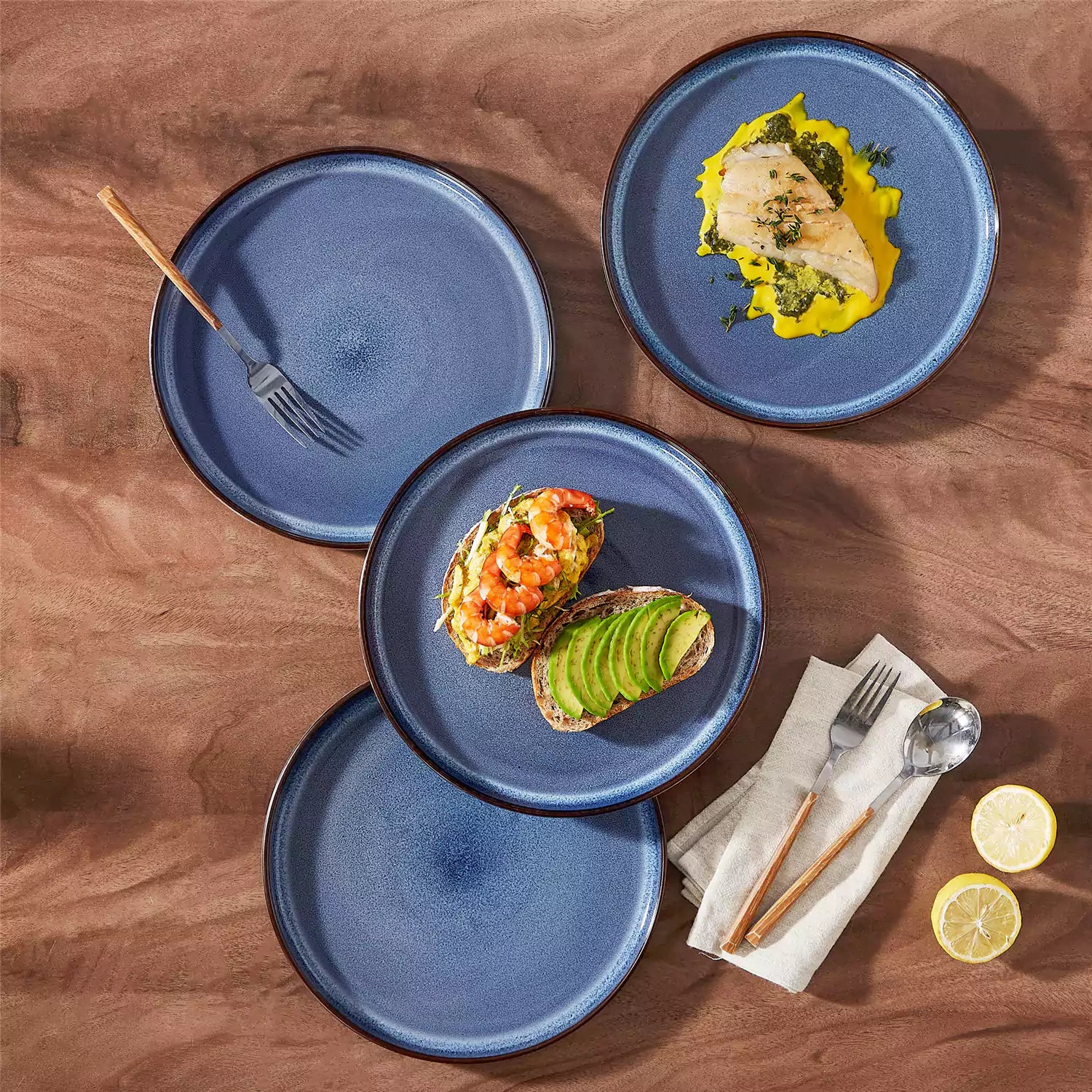 Sata blue stoneware dinner plate set of 4 styled with lamb chops and vegetables on a dinner table farmhouse lipped edge reactive glaze one of a kind finish