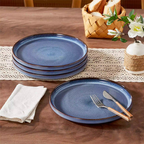 Sata blue stoneware dinner plate set of 4 styled with lamb chops and vegetables on a dinner table farmhouse lipped edge reactive glaze one of a kind finish