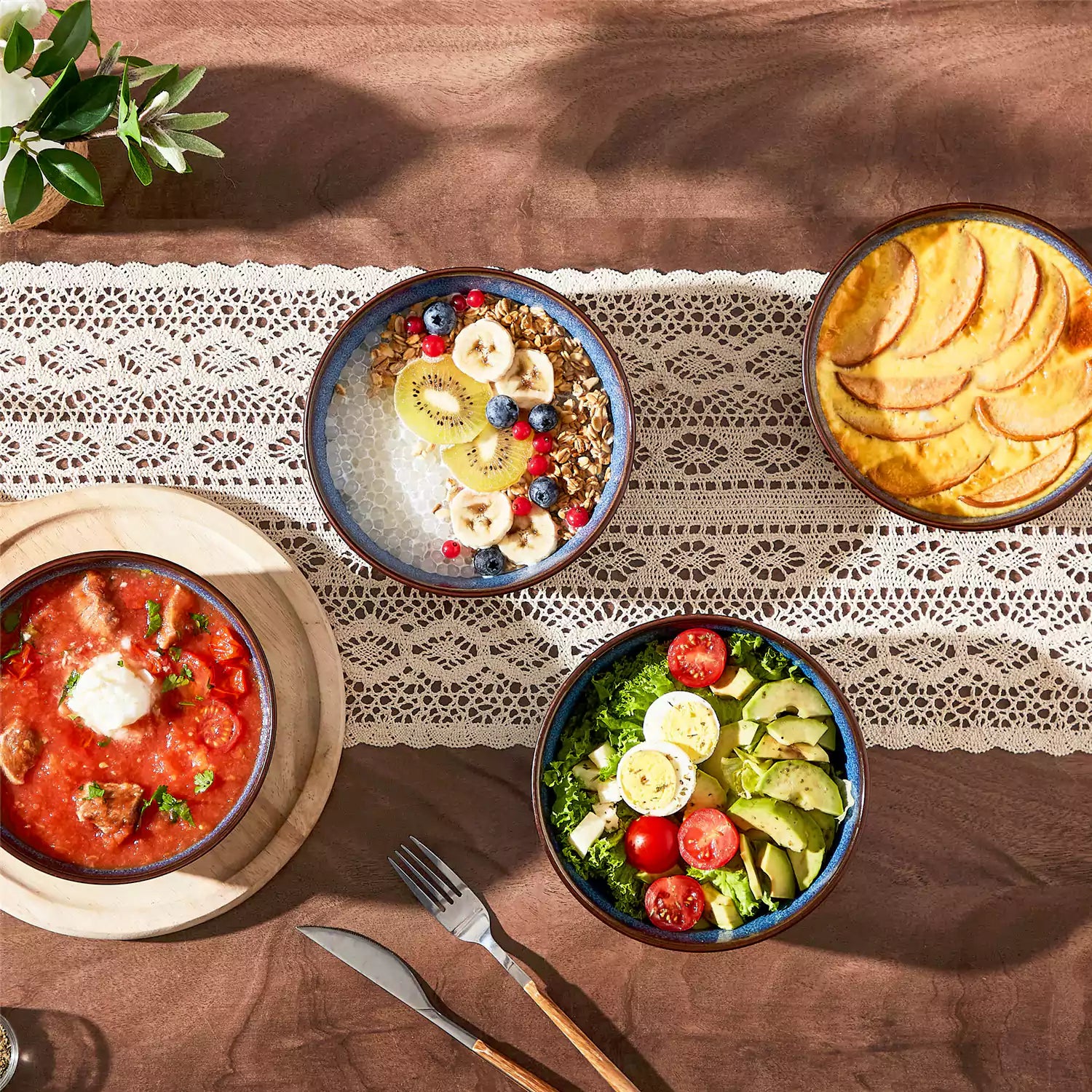 Sata green stoneware cereal bowls set of 4 with assorted meals styled on a wooden table with lace tablecloth farmhouse reactive glaze lipped edge artisan finish