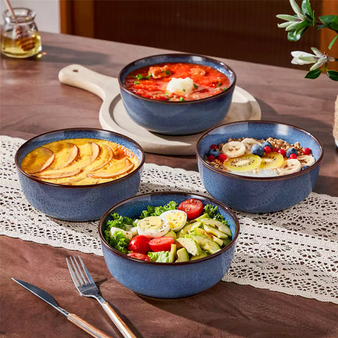 Sata blue stoneware cereal bowls set of 4 with assorted meals styled on a wooden table with lace tablecloth farmhouse reactive glaze lipped edge artisan finish