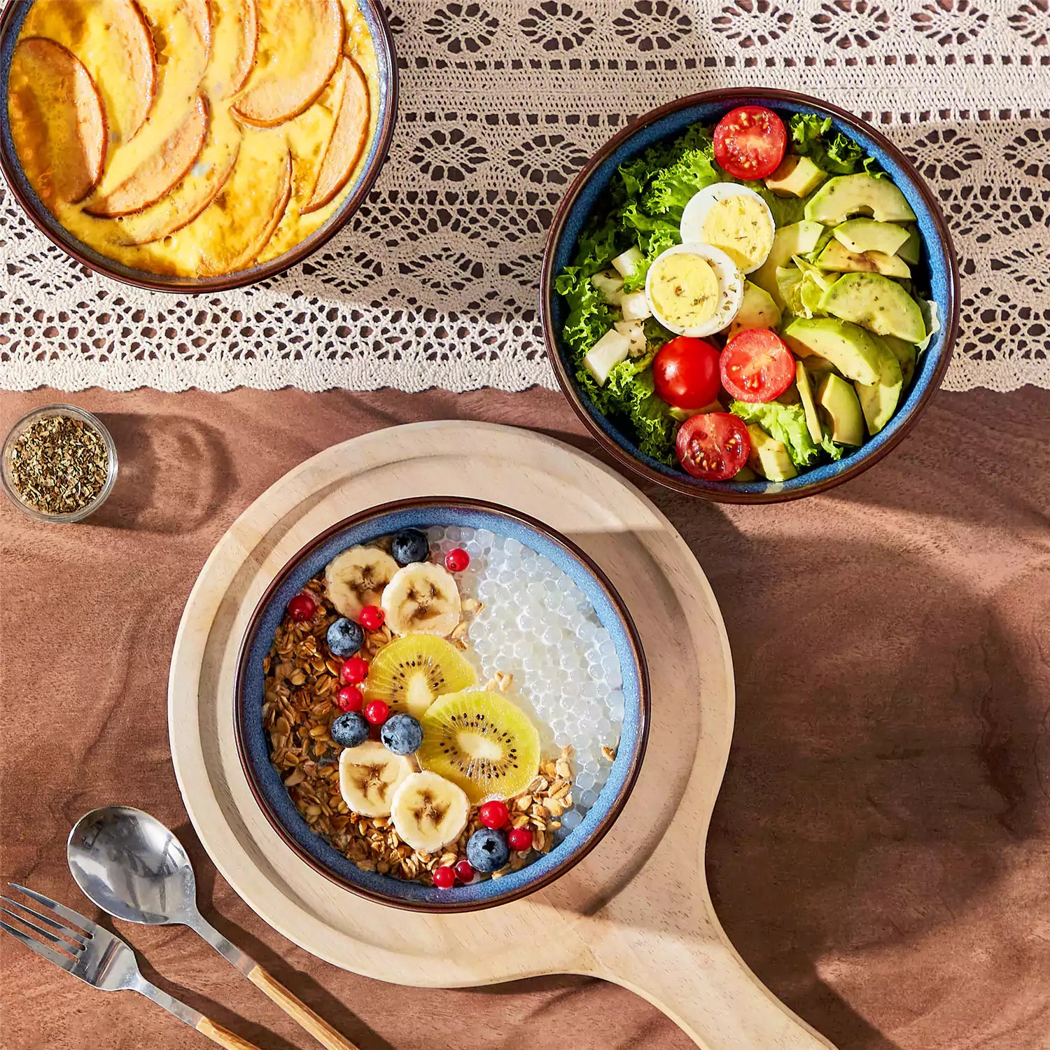 Sata blue stoneware cereal bowls set of 4 with assorted meals styled on a wooden table with lace tablecloth farmhouse reactive glaze lipped edge artisan finish
