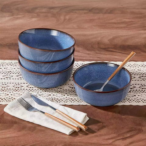 Sata blue stoneware cereal bowls set of 4 with assorted meals styled on a wooden table with lace tablecloth farmhouse reactive glaze lipped edge artisan finish