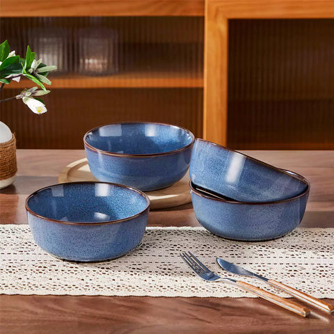 Sata blue stoneware cereal bowls set of 4 with assorted meals styled on a wooden table with lace tablecloth farmhouse reactive glaze lipped edge artisan finish