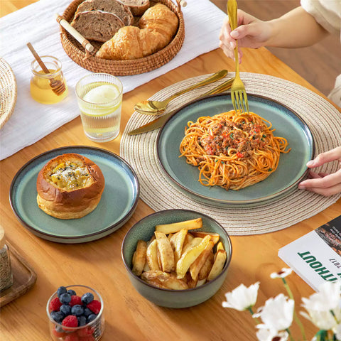 Sata green stoneware 18 piece dinnerware set with dinner plates salad plates and cereal bowls styled on a wooden table with diverse meal setup farmhouse reactive glaze lipped edge service for 6