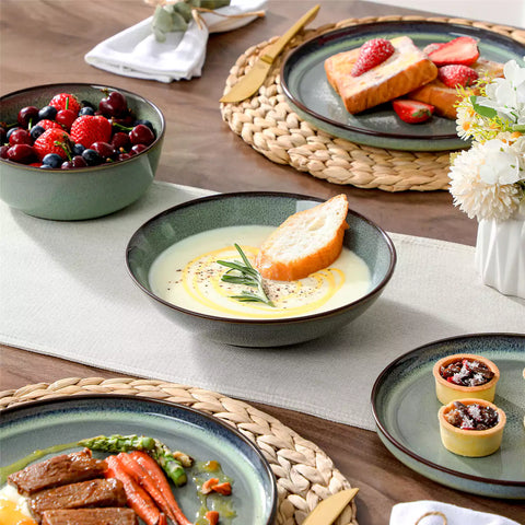 Sata green stoneware dinnerware set styled dining table with dinner plates salad plates pasta bowls cereal bowls silverware and floral centerpiece farmhouse reactive glaze service for 6