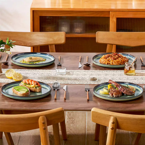 Sata green stoneware dinner plate set of 4 styled with lamb chops and vegetables on a dinner table farmhouse lipped edge reactive glaze one of a kind finish
