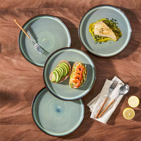 Sata green stoneware dinner plate set of 4 styled with lamb chops and vegetables on a dinner table farmhouse lipped edge reactive glaze one of a kind finish