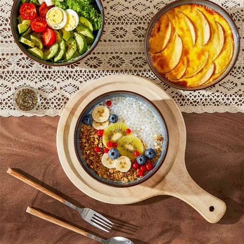 Sata green stoneware cereal bowls set of 4 with assorted meals styled on a wooden table with lace tablecloth farmhouse reactive glaze lipped edge artisan finish