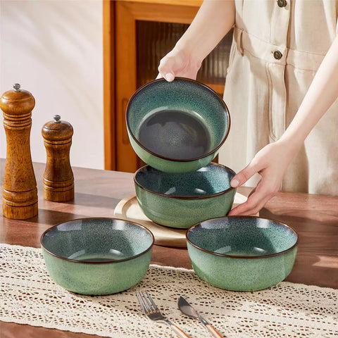 Sata green stoneware cereal bowls set of 4 with assorted meals styled on a wooden table with lace tablecloth farmhouse reactive glaze lipped edge artisan finish