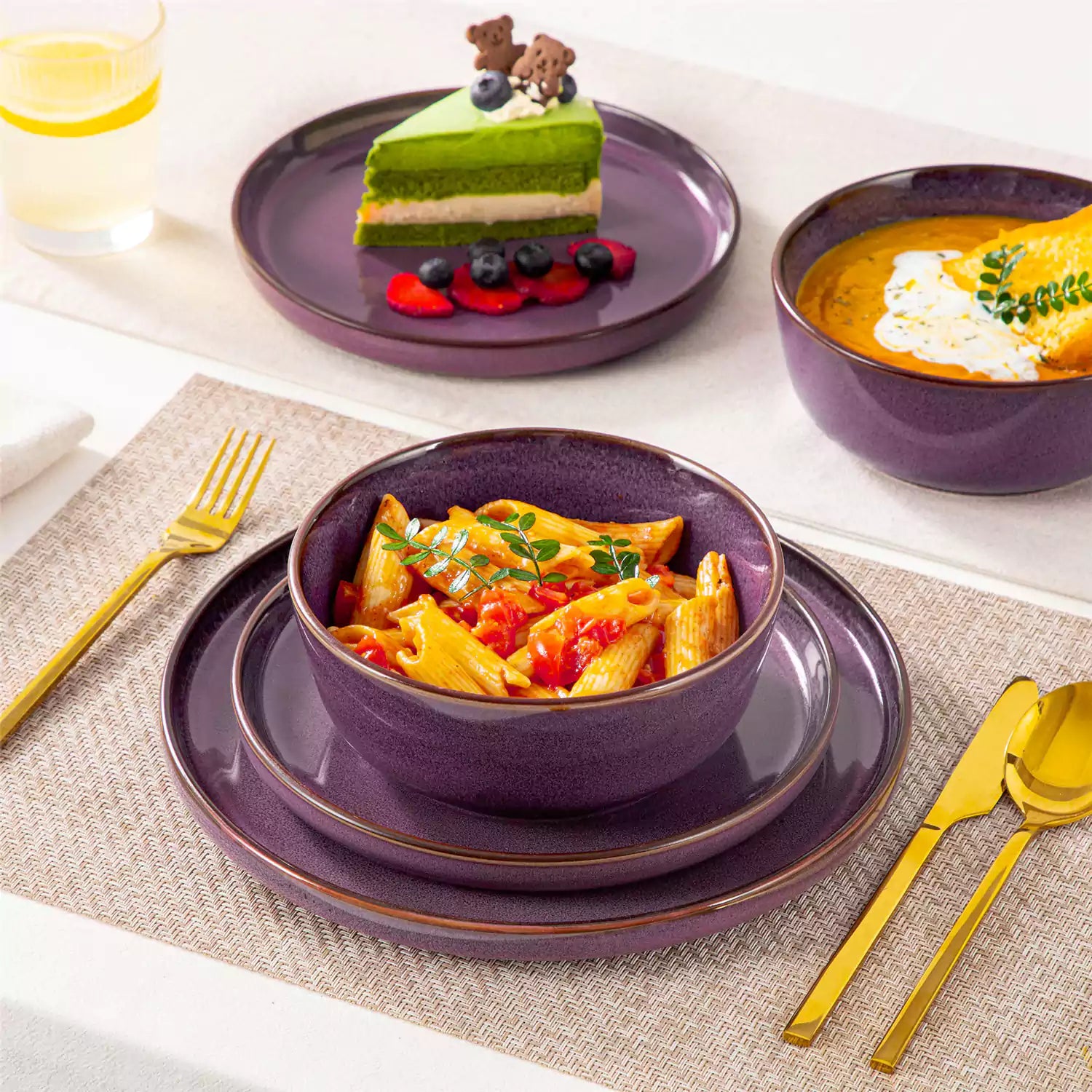 Sata purple stoneware 12 piece dinnerware set with dinner plates salad plates and cereal bowls styled with gold cutlery on textured surface farmhouse reactive glaze lipped edge service for 4