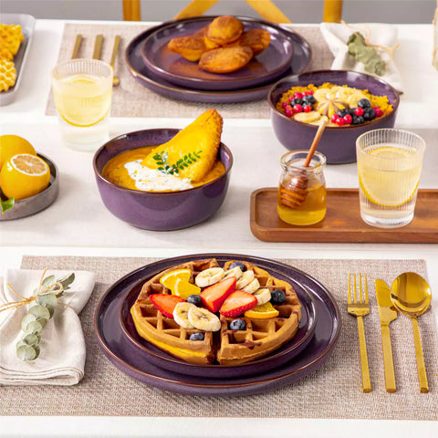 Sata purple stoneware 12 piece dinnerware set with dinner plates salad plates and cereal bowls styled with gold cutlery on textured surface farmhouse reactive glaze lipped edge service for 4